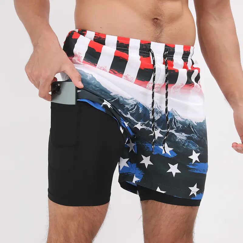 Men printed swim trunks sports beach shorts featuring an American flag-themed mountain range print with a black drawstring waistband.