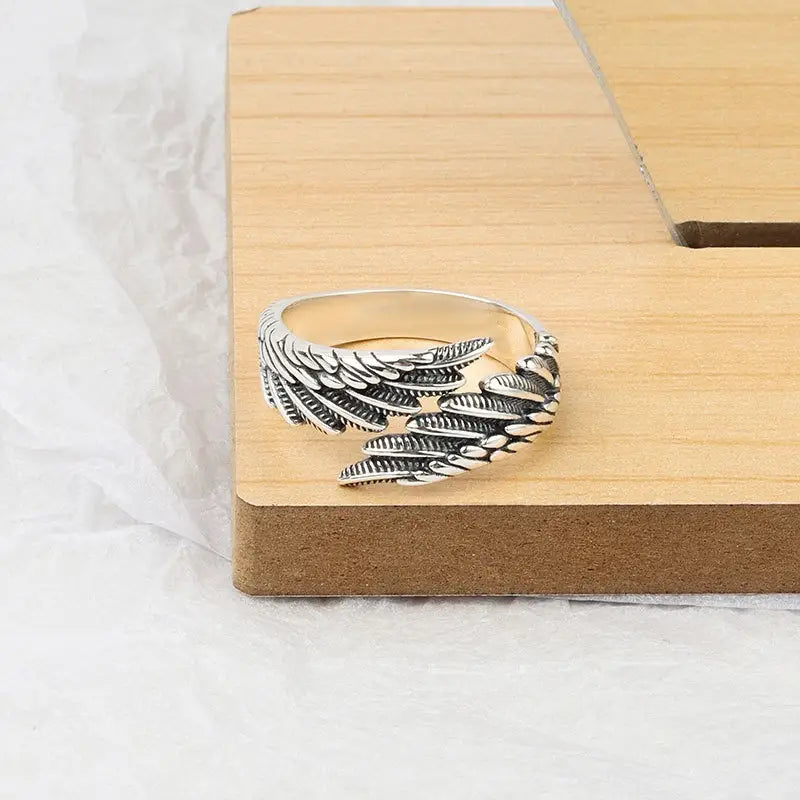 925 sterling silver angel wing ring featuring intricate feather detailing in silver color.