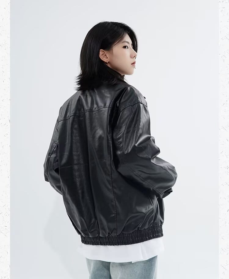 Men’s black faux leather bomber jacket with elasticized cuffs and hem featuring a relaxed fit design for comfortable outerwear use.