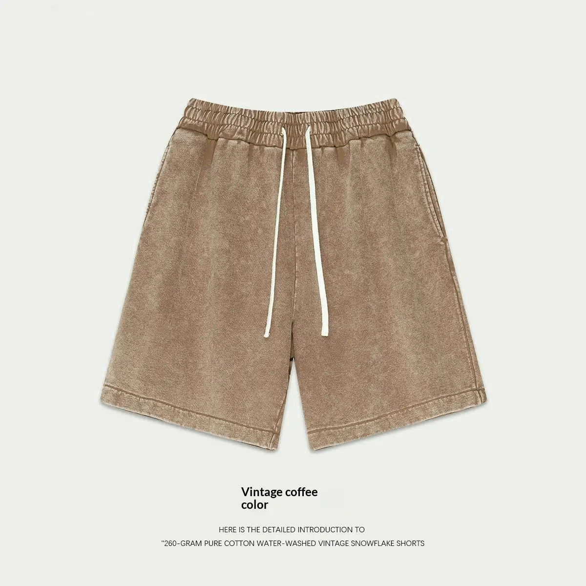 Mens distressed cotton shorts in vintage coffee color featuring a relaxed fit and white drawstrings made from water-washed cotton ideal for summer apparel.