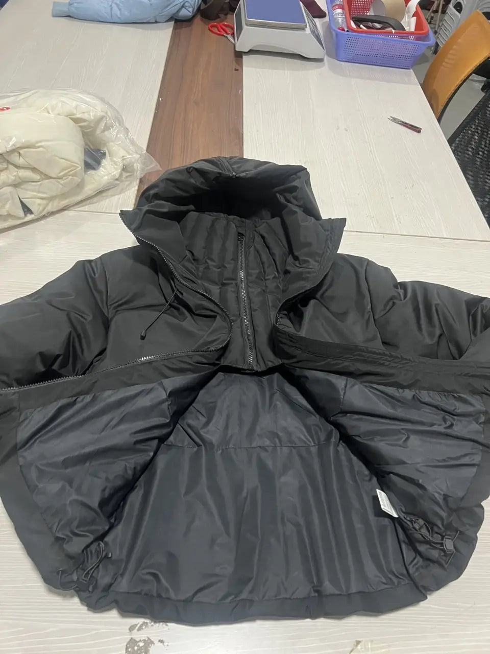 women’s black belted hooded puffer coat with zipper closure designed for warmth and style