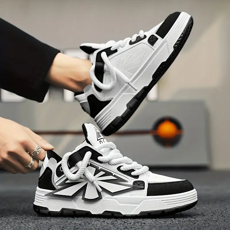 White and black chunky sneakers for men featuring a bold geometric star design, thick rubber soles, and braided laces in a high-top Harajuku style.