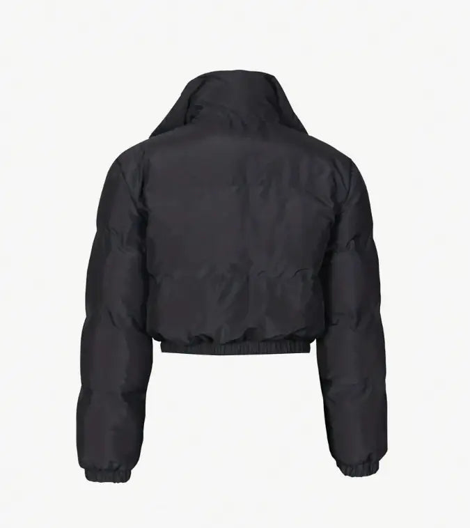 Chaqueta acolchada tipo puffer para mujer en color negro, con cuello alto y puños elásticos, diseñada como abrigo exterior abrigado con cremallera.