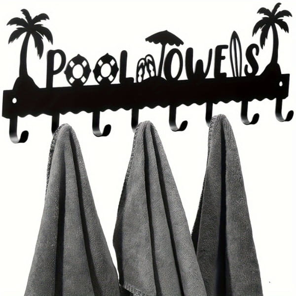 Black metal wall mounted pool towel rack with eight hooks and palm tree beach-themed cutouts spelling pool towels.