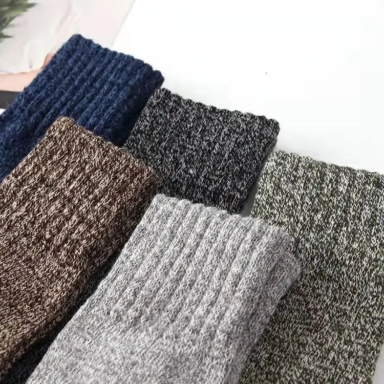 A collection of men’s rabbit fur winter socks in ribbed knit fabric featuring solid and heathered colors such as navy blue brown gray black and olive green.