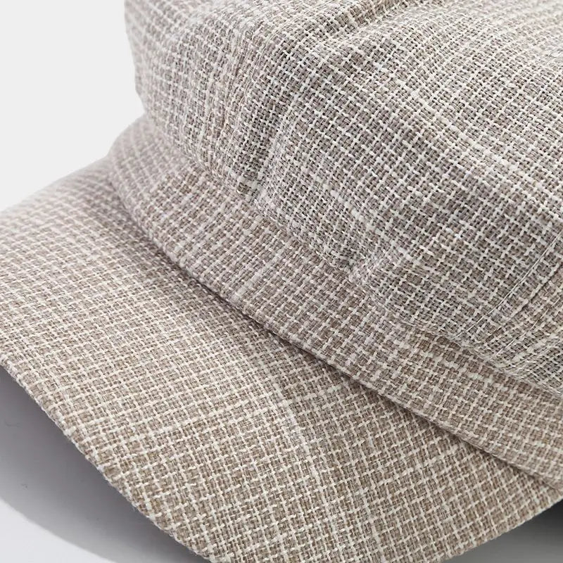 Beige and white checkered bucket hat with textured woven fabric designed as a British style tweed octagonal cap for women.