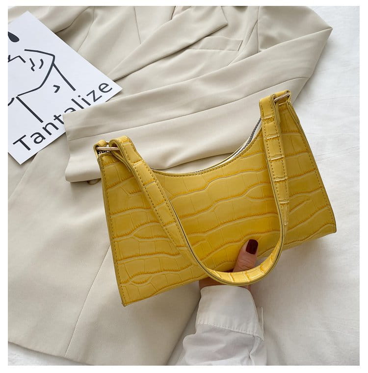 Vibrant yellow crocodile embossed pu leather crescent messenger bag with sleek structured design and gold tone hardware.