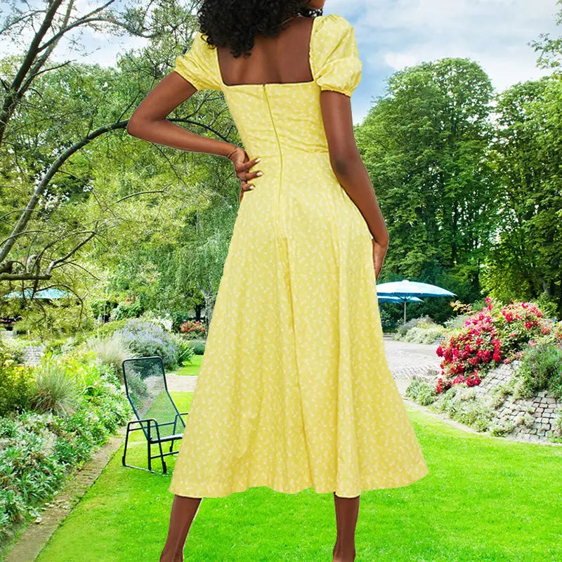 A vibrant yellow floral square neck puff sleeve midi slit dress with a subtle white polka dot pattern, puffed short sleeves, and a square neckline.
