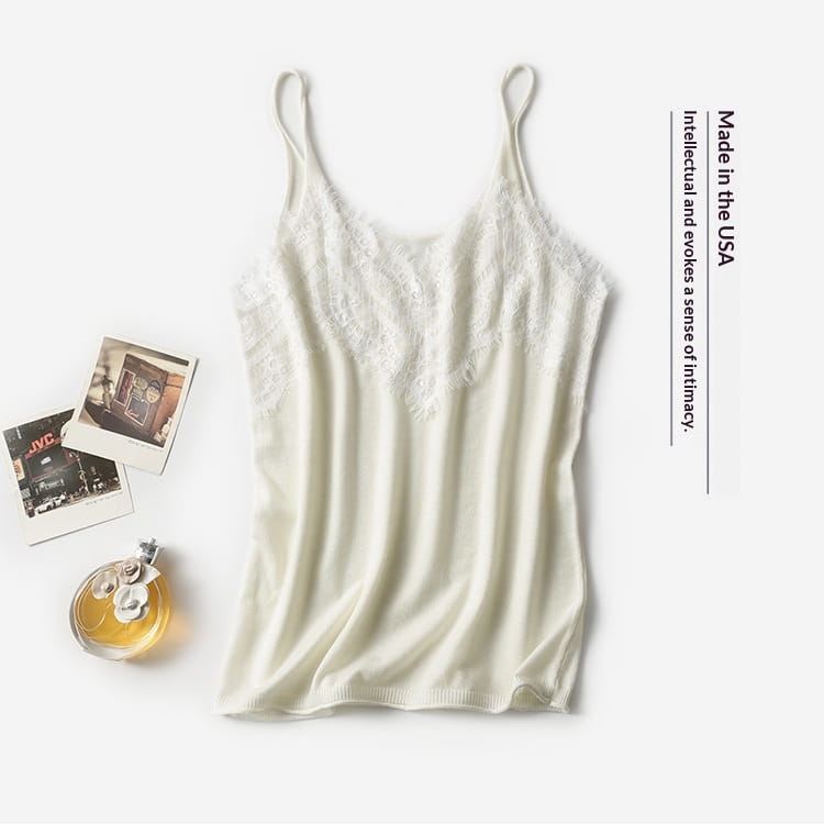 A delicate off-white lace trim camisole top with thin spaghetti straps made of soft flowing knit fabric.