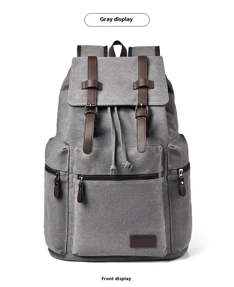 Gray canvas men’s travel backpack with brown leather straps and accents, featuring large 20-35L capacity.