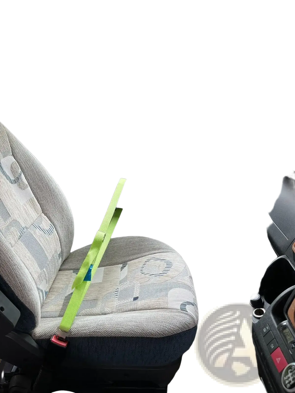 A bright lime green cab lok motorhome seat strap with a red buckle on a patterned van passenger seat fabric