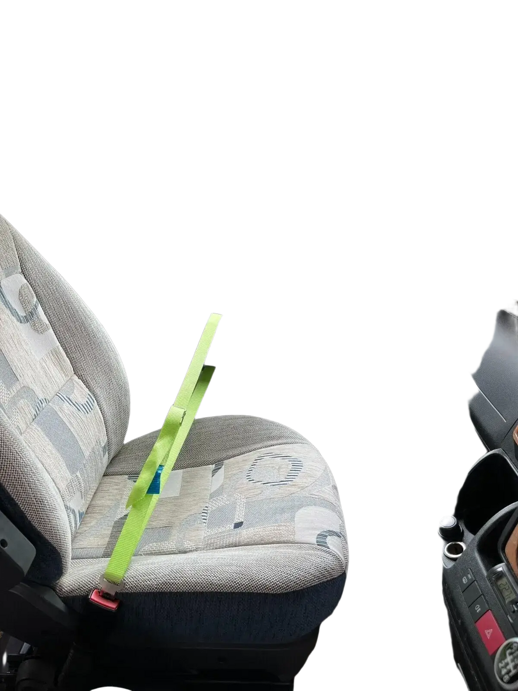 A bright lime green cab lok motorhome seat strap with a red buckle on a patterned van passenger seat fabric