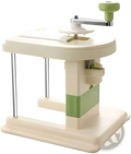 Cream-colored plastic cabbage shredder with a green handle and metallic crank for stainless steel vegetable slicing