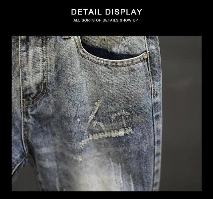 Distressed maple leaf denim shorts in blue denim with faded wash and intentional tear details.