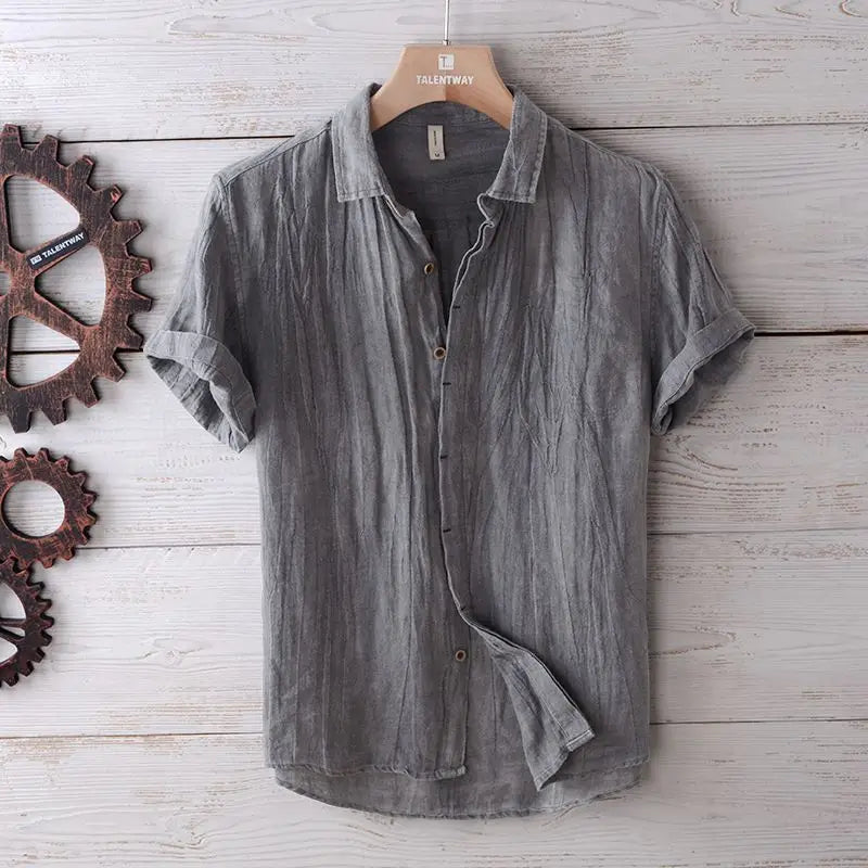 Men’s retro distressed gray linen short sleeve shirt with textured fabric hanging on a wooden hanger