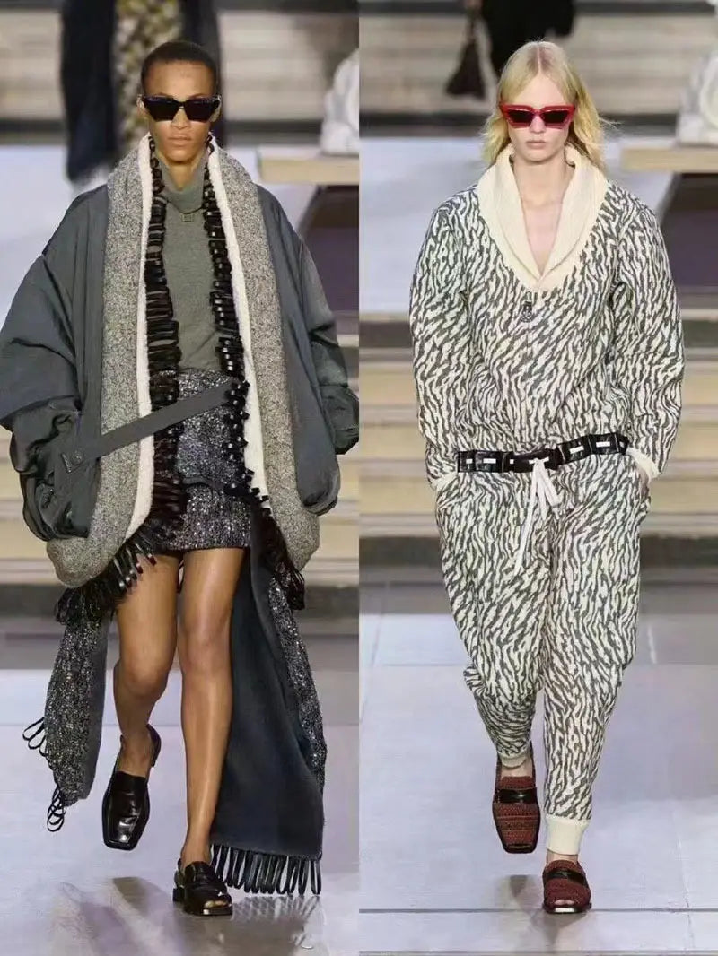 Two models on a runway wearing modern irregular cat eye uv400 geometric sunglasses featuring bold frames and contemporary design.