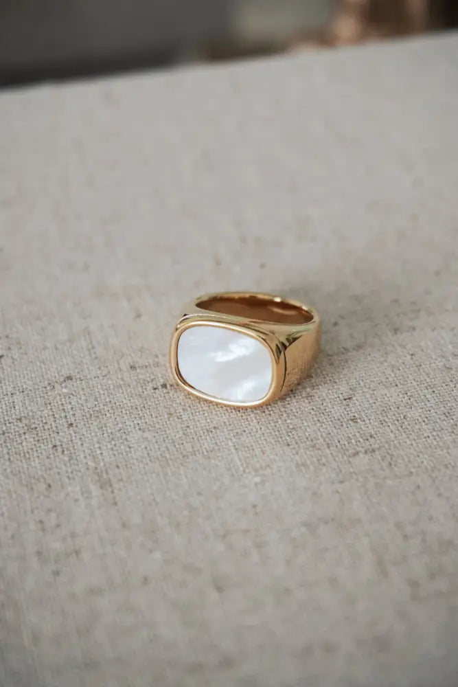 Calypso gold signet ring with smooth oval mother of pearl inlay in a gold-tone finish