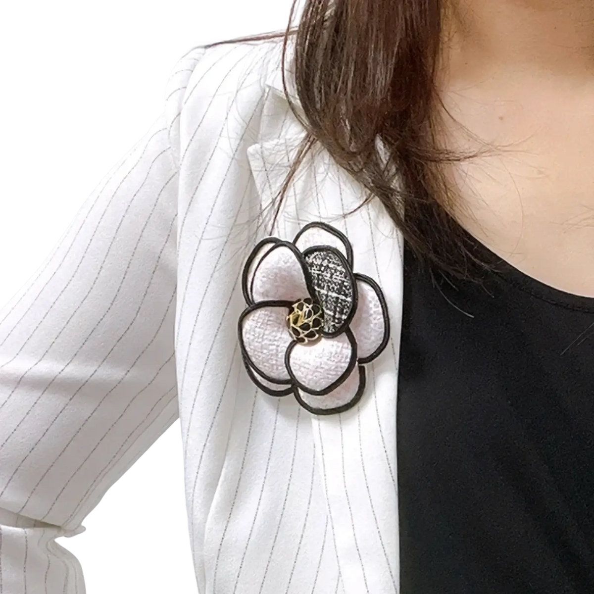 Camellia fabric flower brooch with delicate white and black floral design and textured center outlined in dark thread