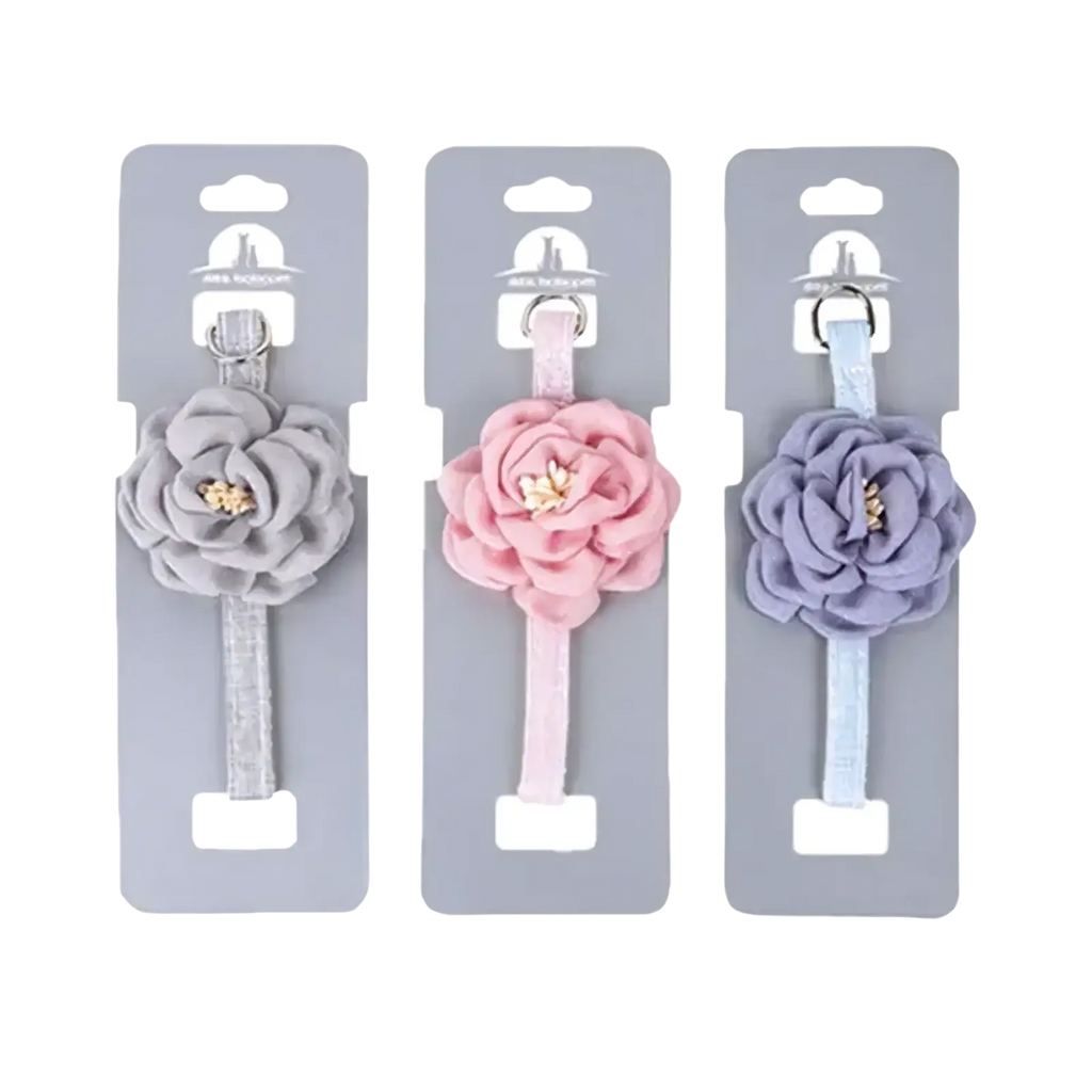 Three pastel camellia flower adjustable cat collars with layered fabric roses and gold center embellishments on elastic bands