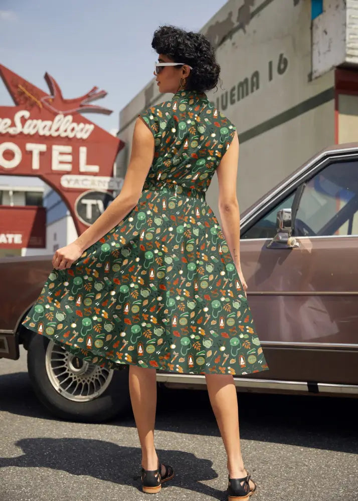 Vintage camping print cotton bow top in dark green featuring a playful pattern of colorful mushrooms and leaves