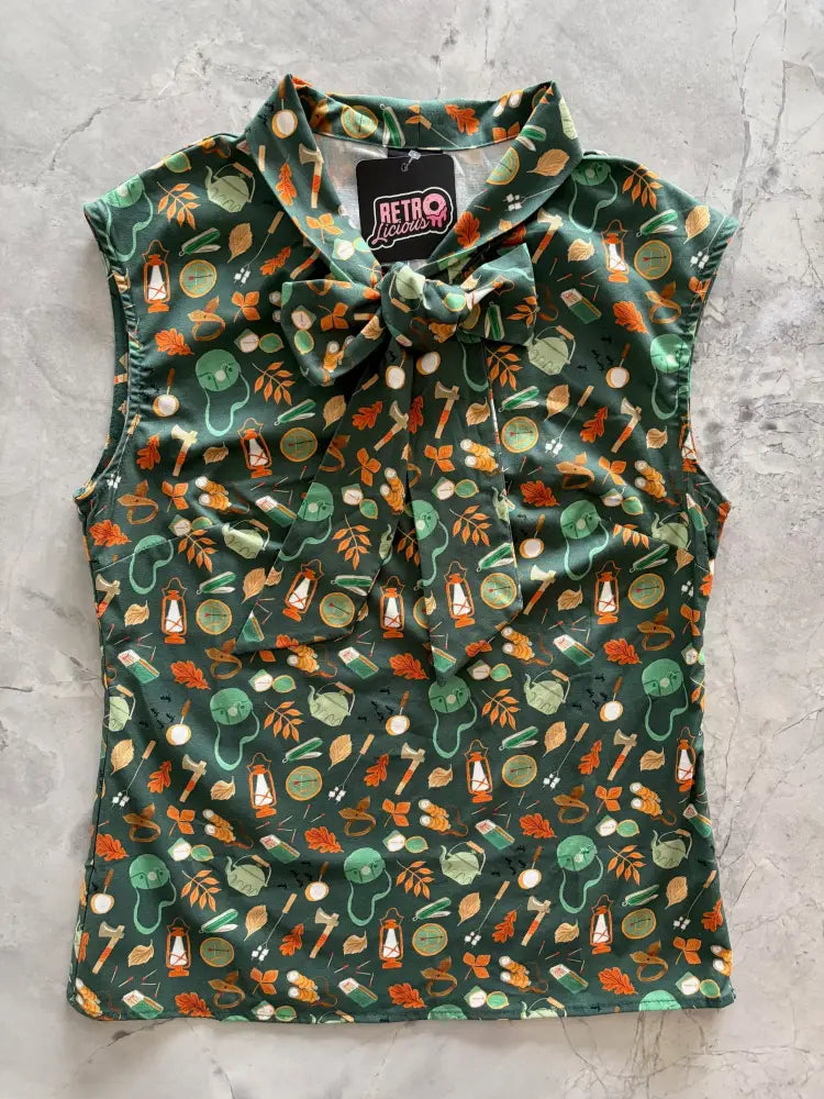 Dark green vintage camping print sleeveless cotton top featuring autumn themed icons in orange and teal