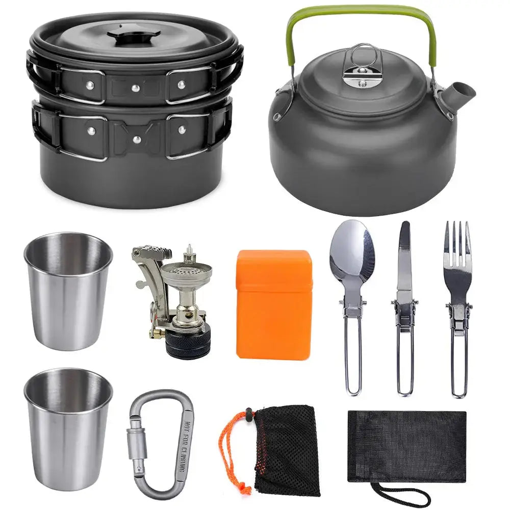 Black aluminum camping cookware set with green handle kettle and stainless steel utensils for outdoor cooking