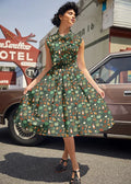 Camping Doris retro cotton flared skirt in green with colorful vegetable and fruit pattern featuring fitted bodice and pockets