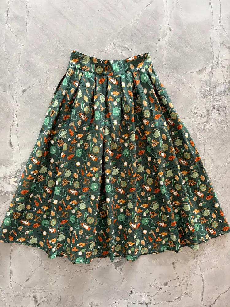 Camping Doris retro cotton flared skirt in dark green with orange and light green kitchen utensil pattern and pockets