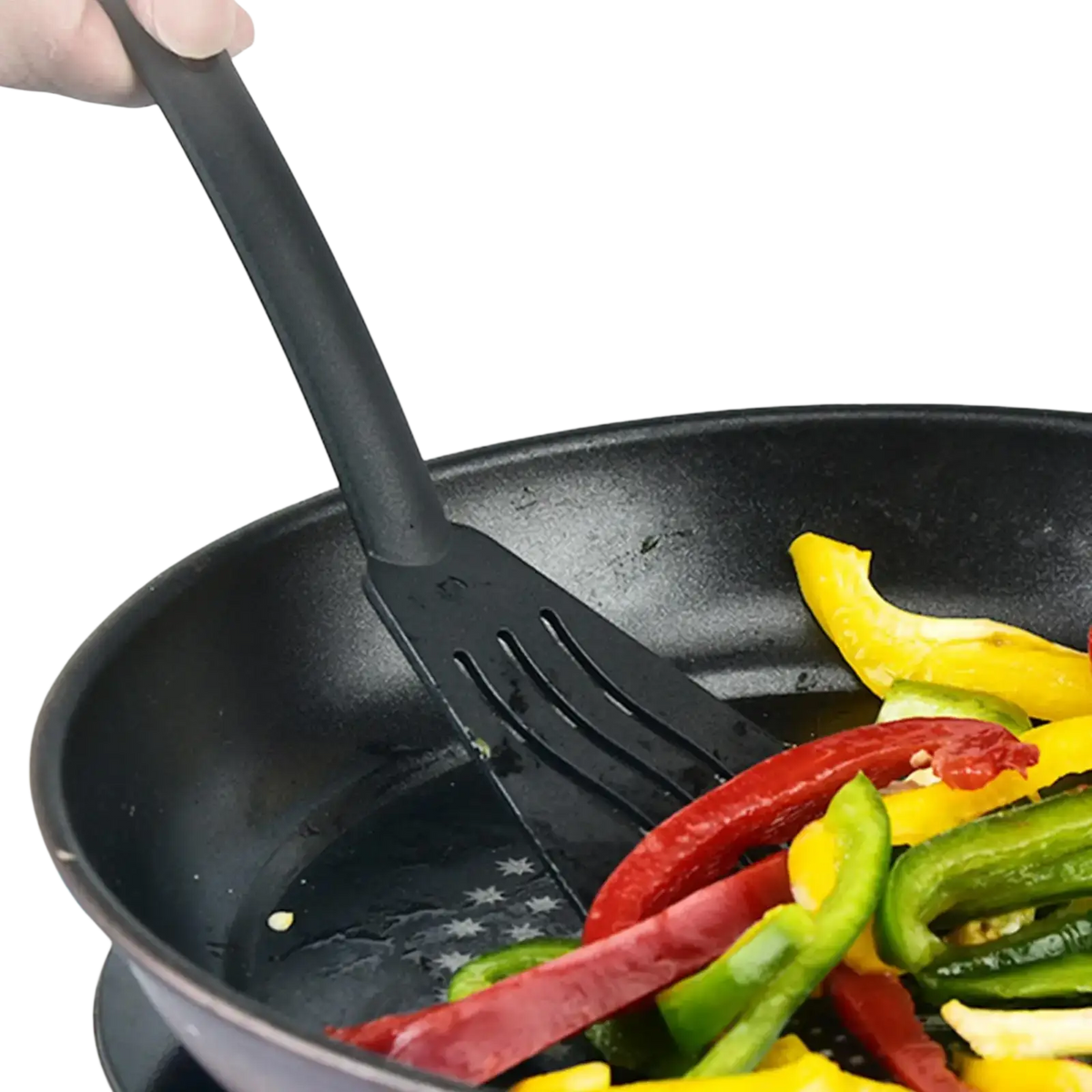 Black silicone spatula with long handle and slotted edges stirring colorful bell peppers in frying pan camping kitchen set