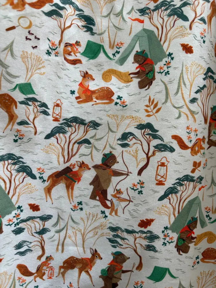 Whimsical woodland animal campsite print vintage fit and flare cotton dress with green tents on cream background