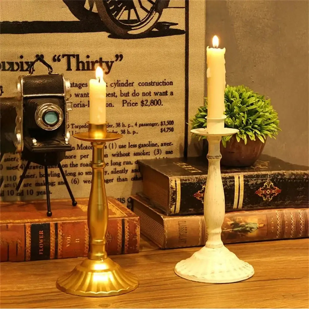 Two vintage-style candle holders in polished gold and distressed white for table decorations modern european hotel wedding