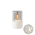 Candlelight aroma diffuser usb mist humidifier with a modern translucent glass dome and copper led bulb on white base