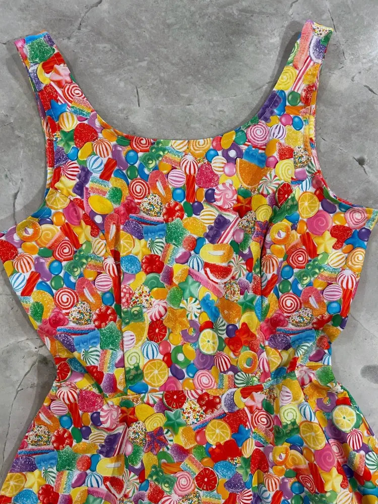 Yellow candy print A-line skater dress with pockets featuring a vibrant sleeveless design and playful colorful sweets pattern