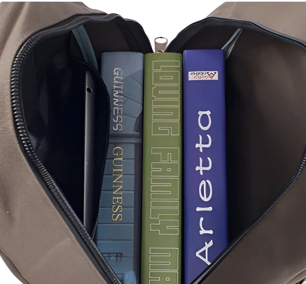 Tan canvas backpack with black zipper containing three books shown in men’s olive green student bag product image