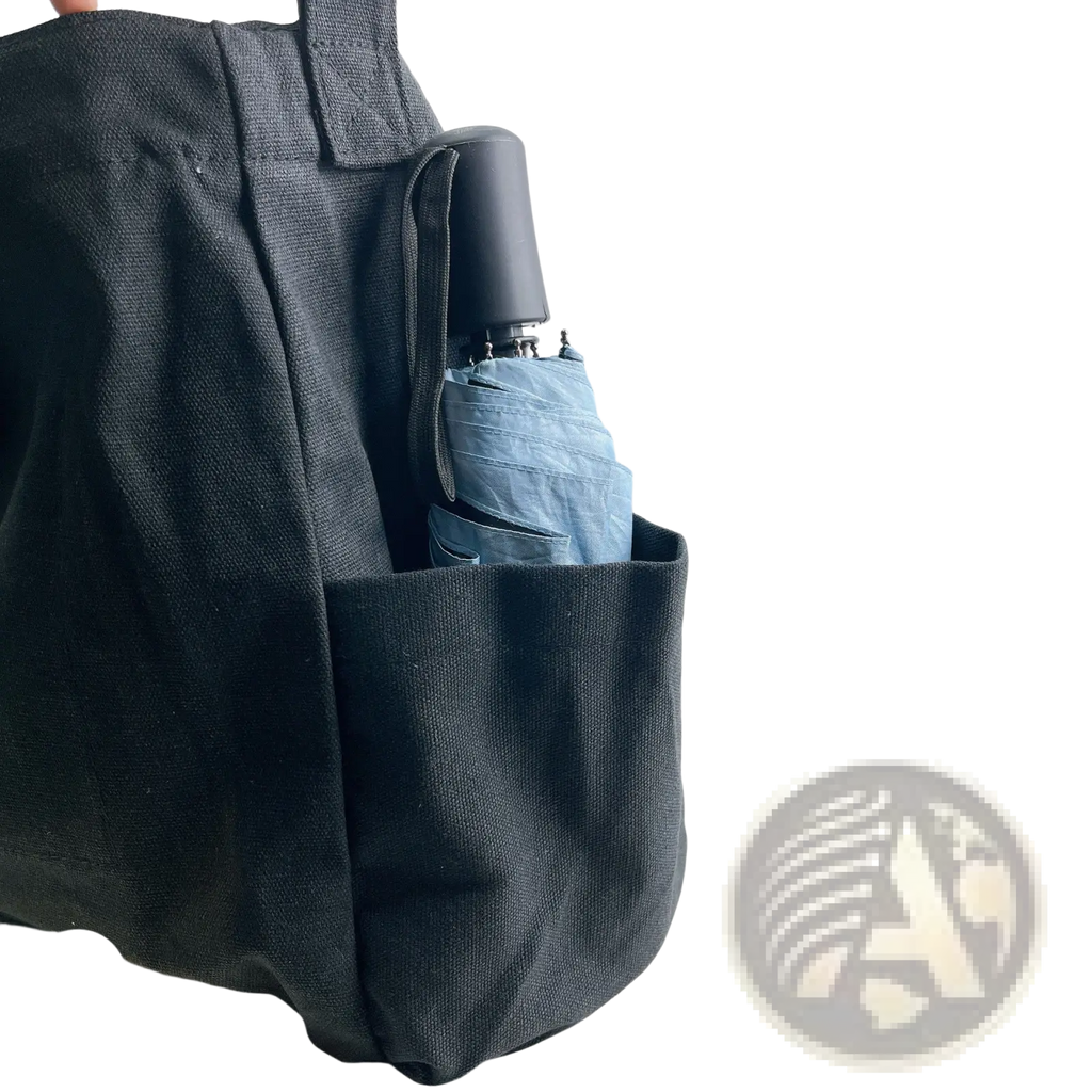 Black canvas large multi pocket retro tote shoulder bag with folded light blue umbrella in side pocket