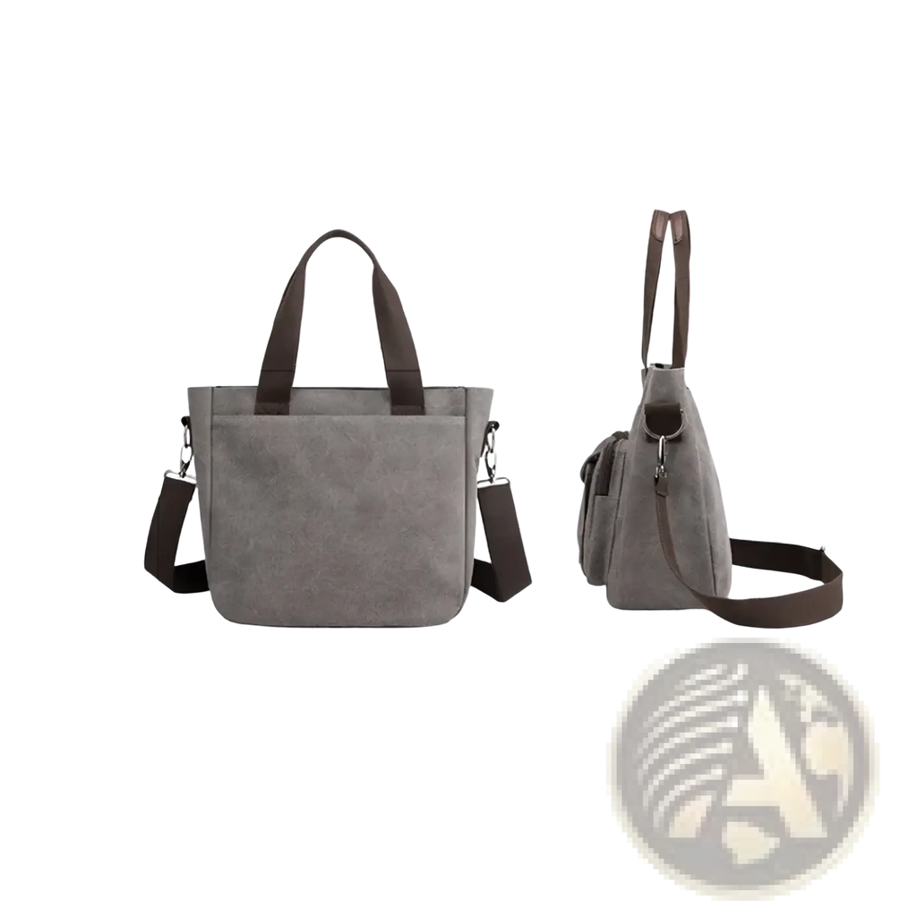 Gray canvas tote bag with brown leather handles and shoulder strap designed for multipocket work use