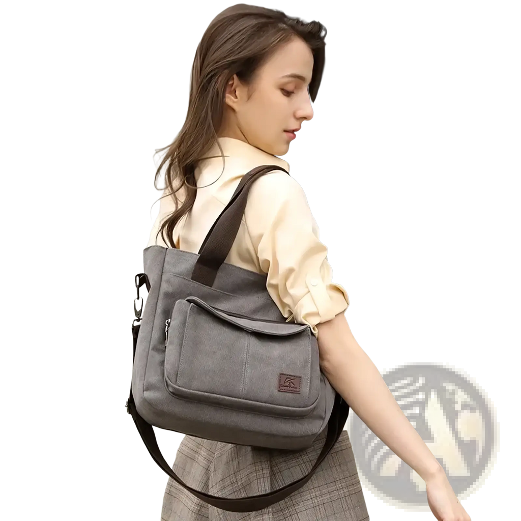 Gray canvas tote bag with brown straps multipocket shoulder handbag featuring a front pocket and small logo patch