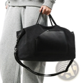 Black canvas travel duffel bag with large capacity waterproof design and textured front panel with adjustable strap