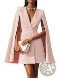 A soft pink cape blazer dress with a double breasted front and flared sleeves in a v neck design