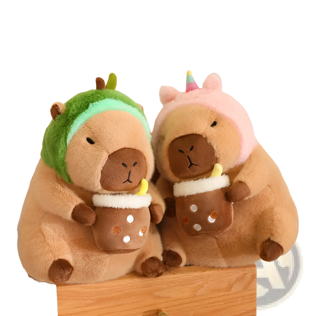 Two plush capybara toys in bread and flower outfits holding brown cups with white polka dots