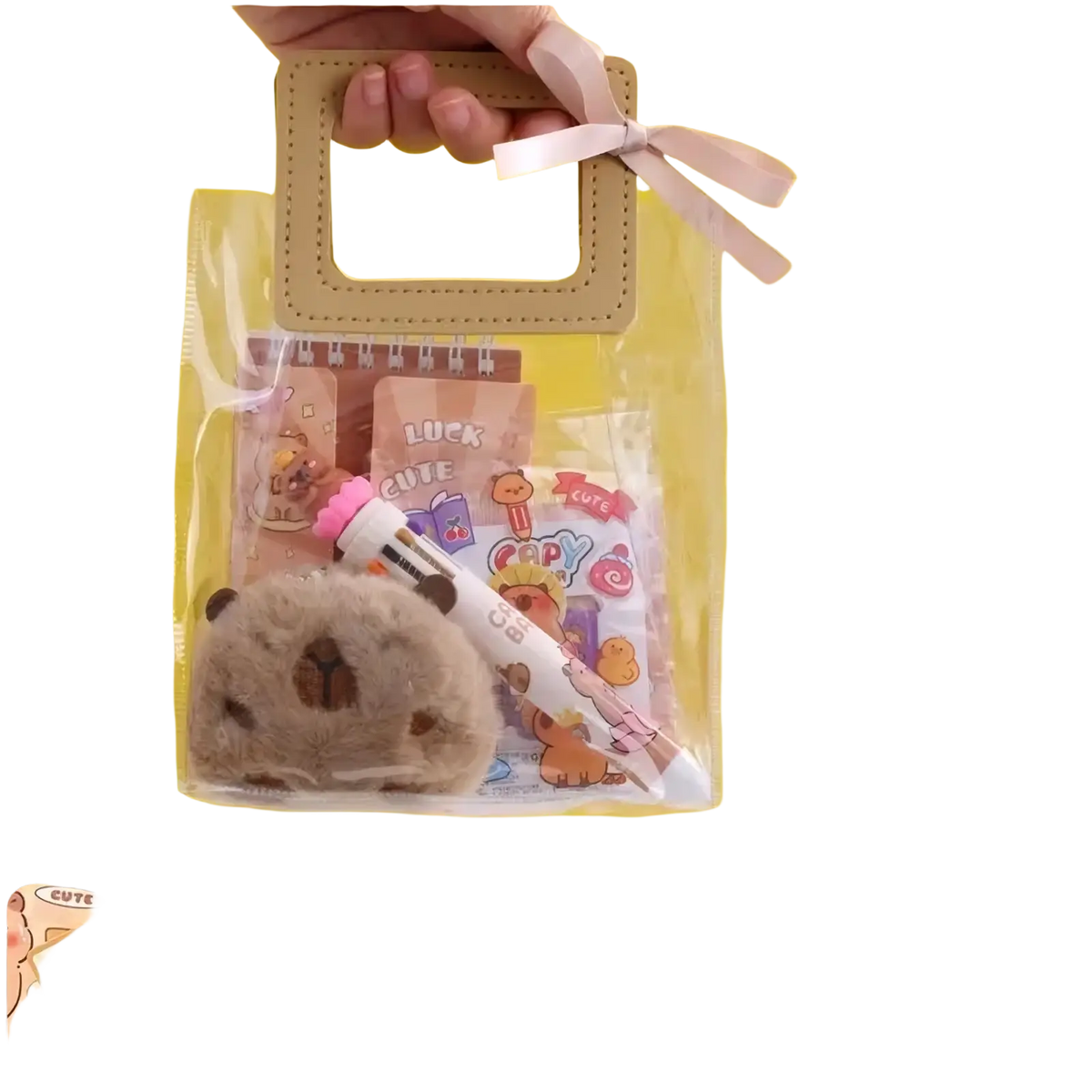 A soft grayish brown plush capybara keychain with embroidered features and pink bow in kawaii student stationery set