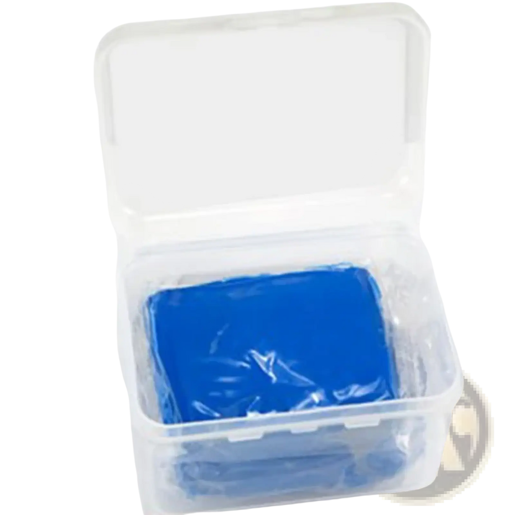 A vibrant blue rectangular car clay bar made of modeling clay inside a clear plastic container for detailing use