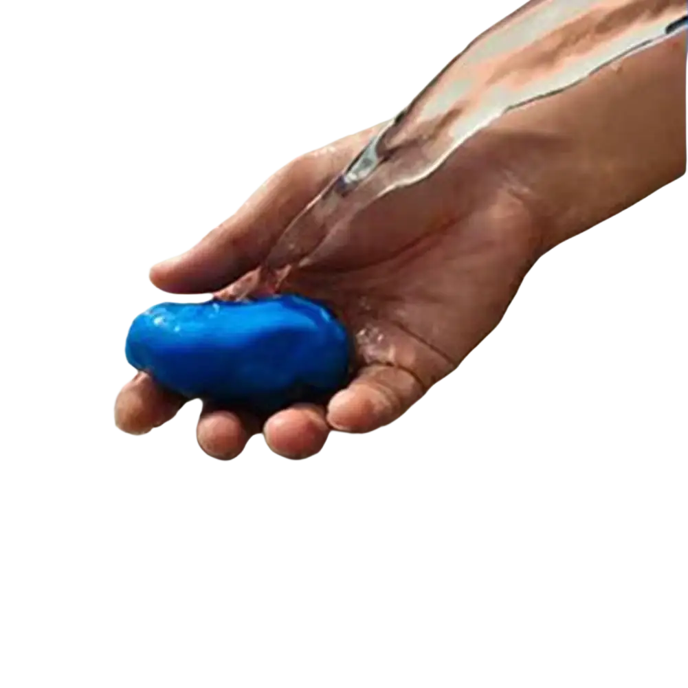 A vibrant blue smooth oval-shaped car clay bar being rinsed as part of a 3 pack detailing mud cleaner set