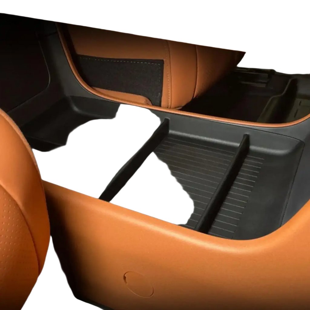 Black plastic car console organizer tray with divided compartments and textured surfaces made of ABS material