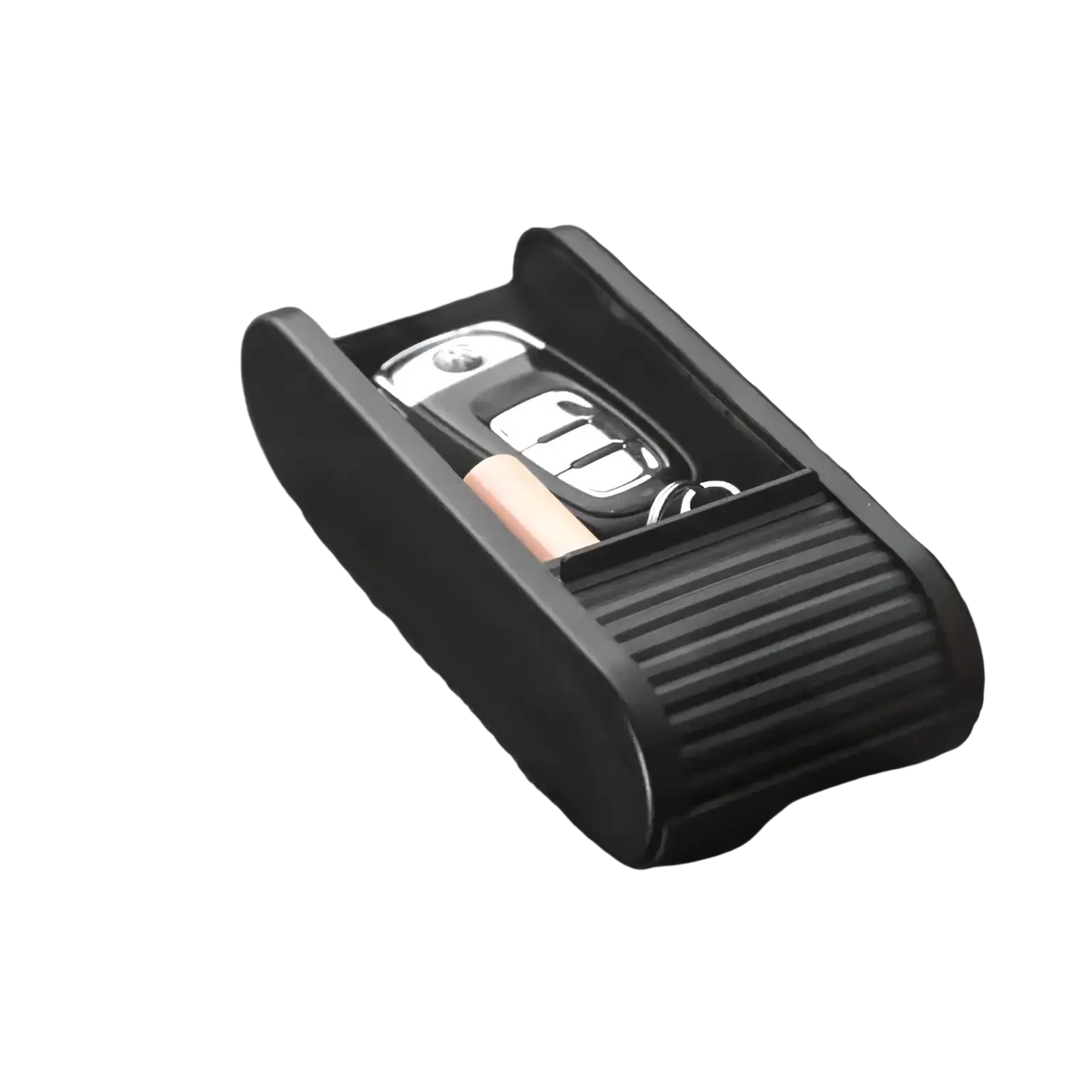 Black plastic car dashboard organizer with ribbed texture and open compartment holding keys and coins