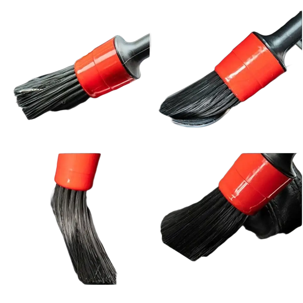 Red-handled car detailing brush with black bristles for cleaning and polishing vehicles