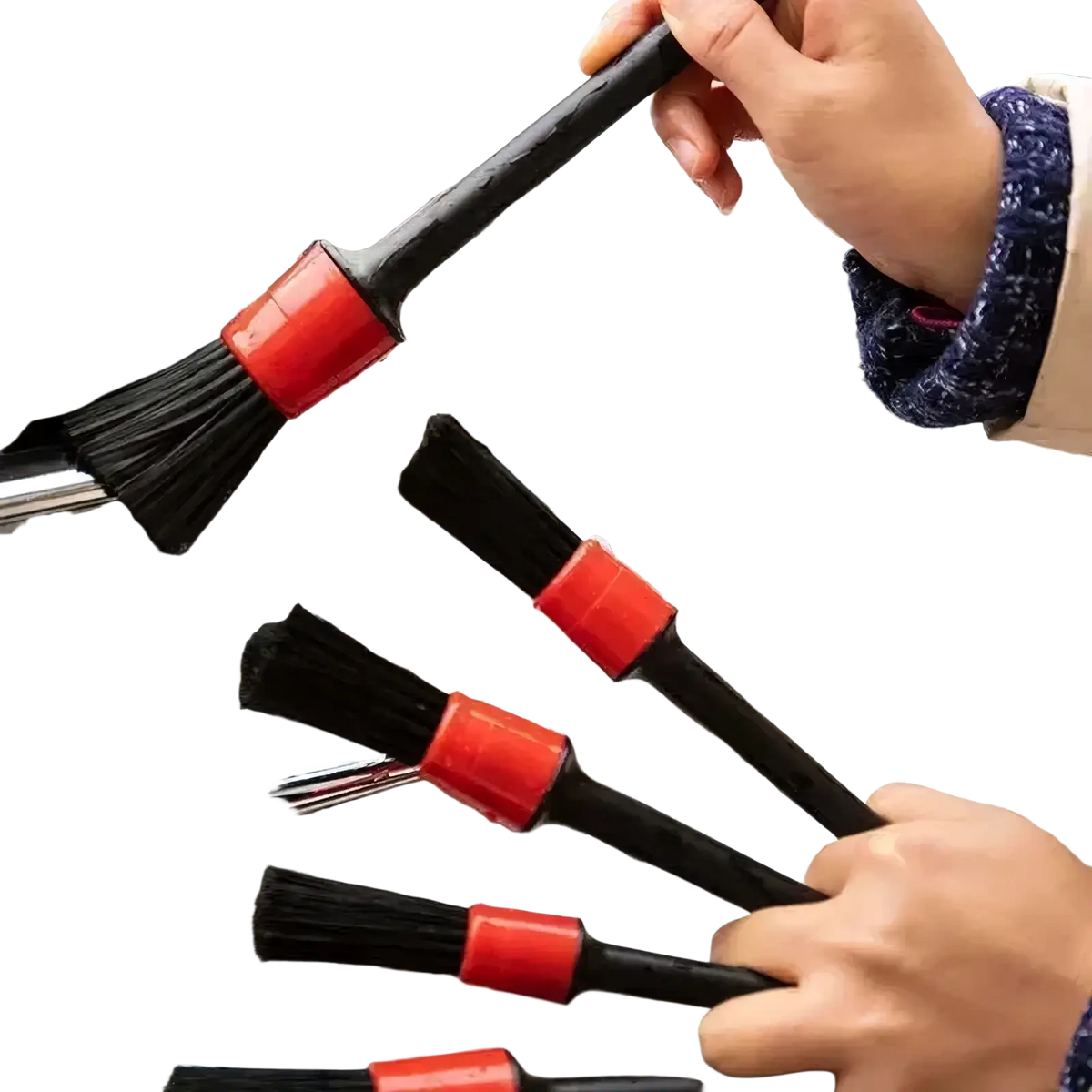 Black car detailing brushes with bright red plastic handles scrubbing a soapy chrome grille from a 5-piece set
