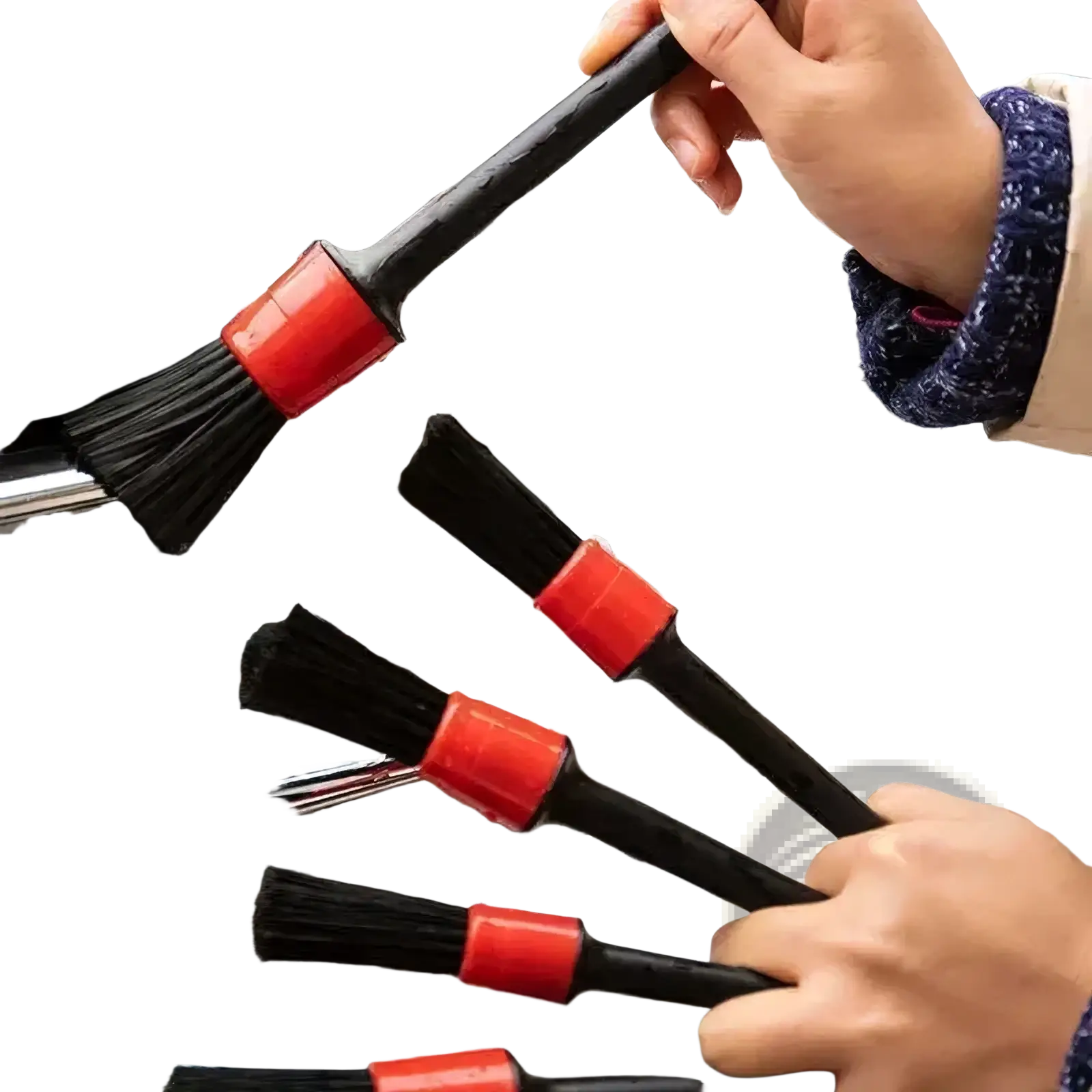Black car detailing brushes with bright red plastic handles scrubbing a soapy chrome grille from a 5-piece set