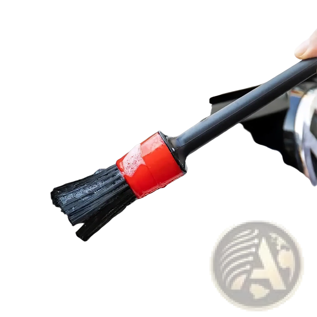 Black microfiber car detailing brush with red handle being used for deep cleaning in a 5-piece brush set