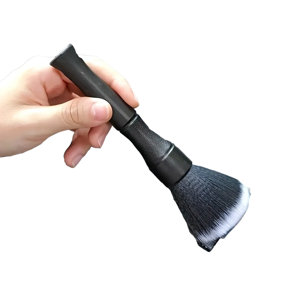Black car interior soft bristle detailing brush with dense soft bristles and textured grip handle shown from the back side
